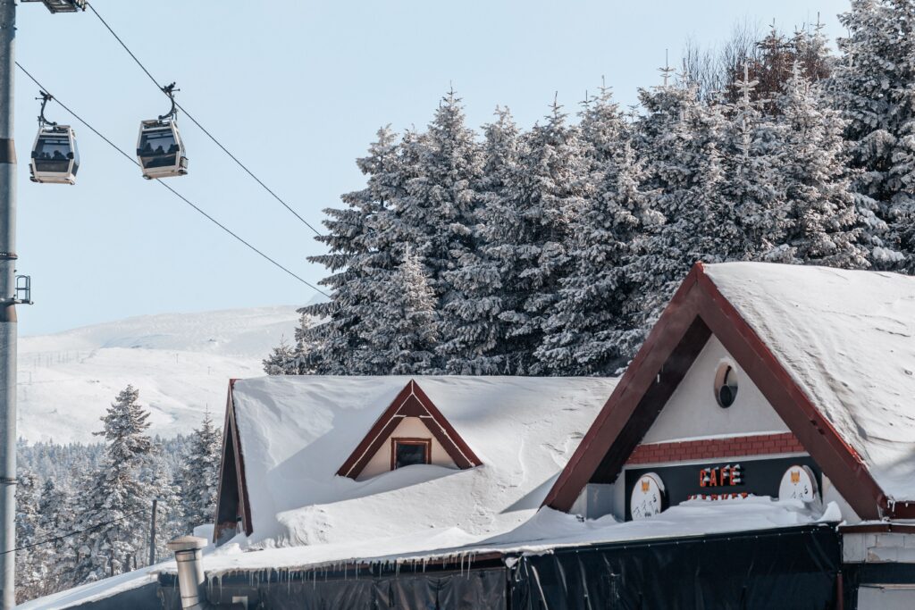 Charming snowy ski resort in Bursa, Türkiye with cable cars and frosted pine trees in winter.